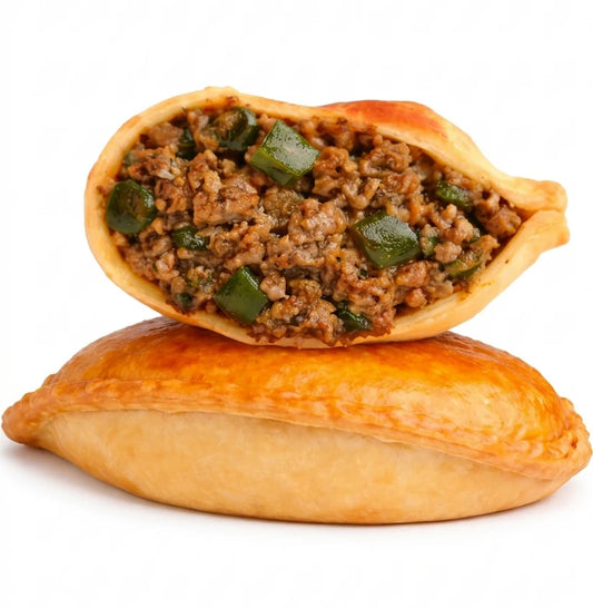 Santanas Handmade Sonoran Ember Bison empanadas with seasoned bison, roasted poblano peppers, hominy, and flaky golden pastry on a white background